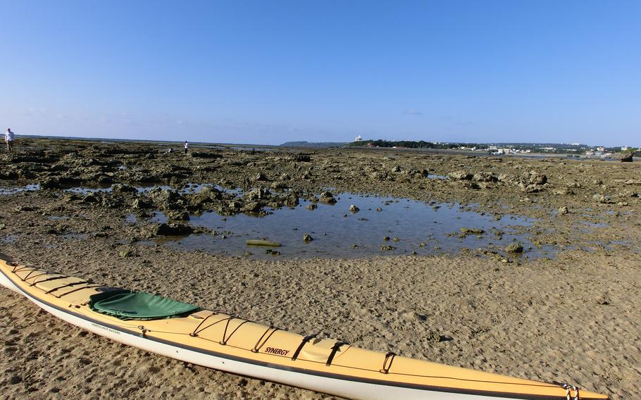 A canoe is visible on the beach.